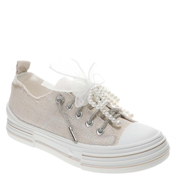 Neutral fabric women’s slip-on sneaker with pearl laces, chiffon bow, and glitter lace details at Oaklynn & Ivy Co.