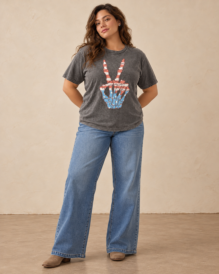 Stone gray mineral-washed plus-size boyfriend tee featuring a skeleton hand peace sign filled with red, white, and blue stars and stripes.