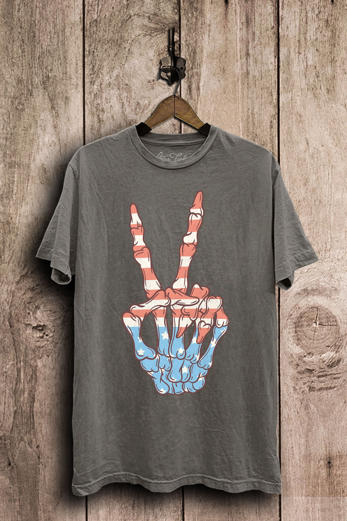 Stone gray mineral-washed plus-size boyfriend tee featuring a skeleton hand peace sign filled with red, white, and blue stars and stripes.