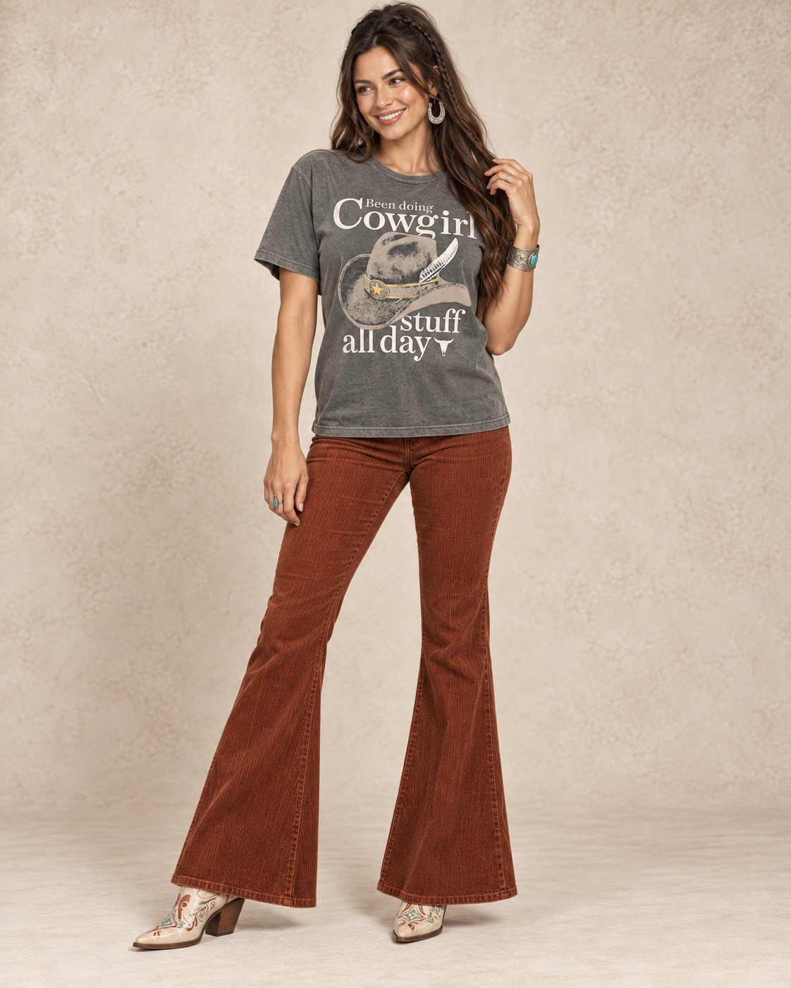 Stone-gray mineral-wash boyfriend tee with a vintage cowboy hat and Been Doing Cowgirl Stuff All Day lettering.