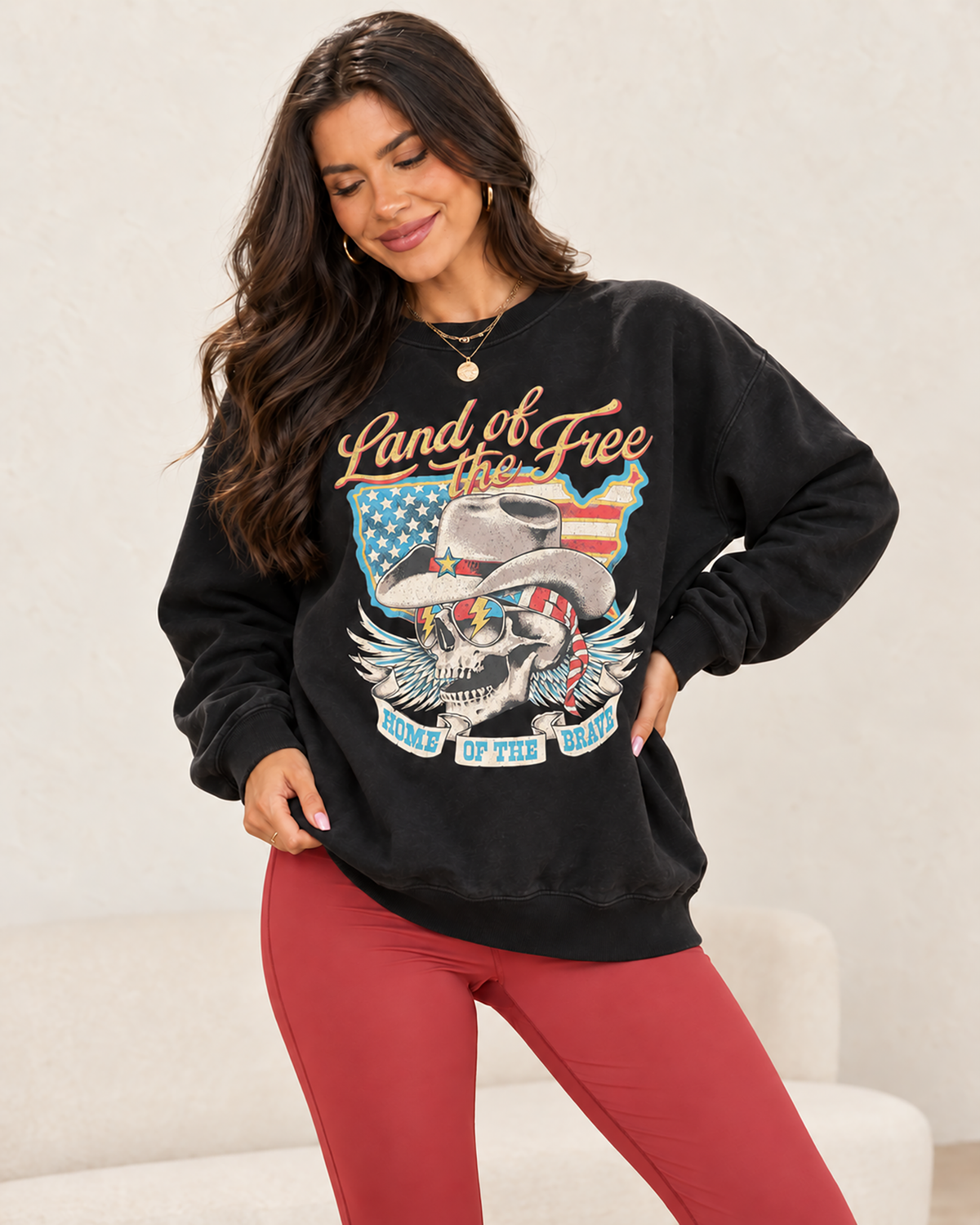 lack French terry sweatshirt featuring a cowboy skull in a western hat, star sunglasses and American flag bandana with wings, a flag-filled map and patriotic lettering.