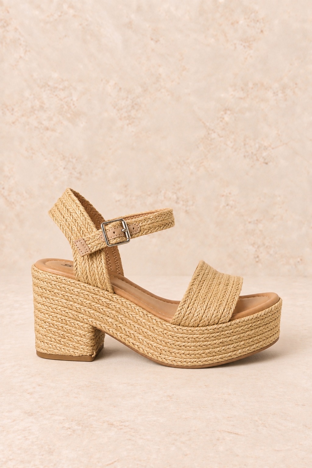 Natural woven raffia platform sandal with a wide front strap, adjustable ankle buckle, cushioned footbed, and chunky block heel.