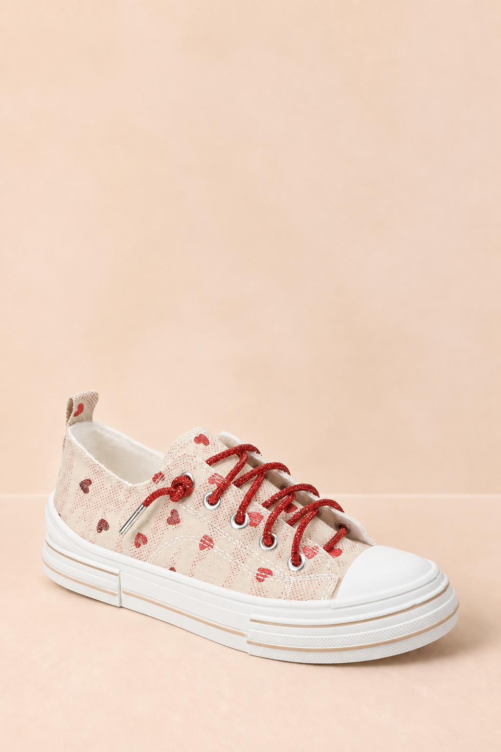 Natural canvas Very G platform sneaker with scattered red hearts, sparkling red rhinestone laces, a white toe cap, and a chunky white sole.