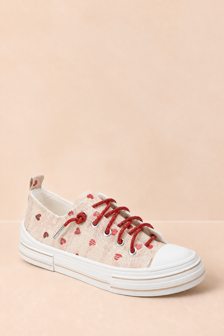 Natural canvas Very G platform sneaker with scattered red hearts, sparkling red rhinestone laces, a white toe cap, and a chunky white sole.