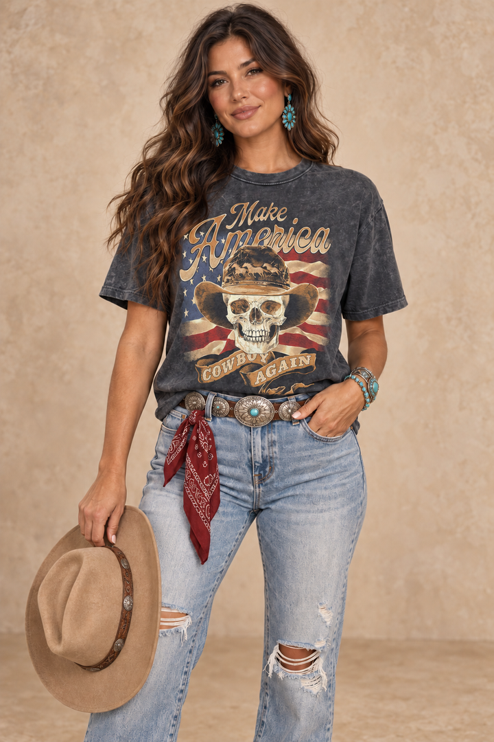 Vintage black mineral-wash boyfriend tee featuring Make America Cowboy Again lettering, a cowboy skull, and a distressed American flag.