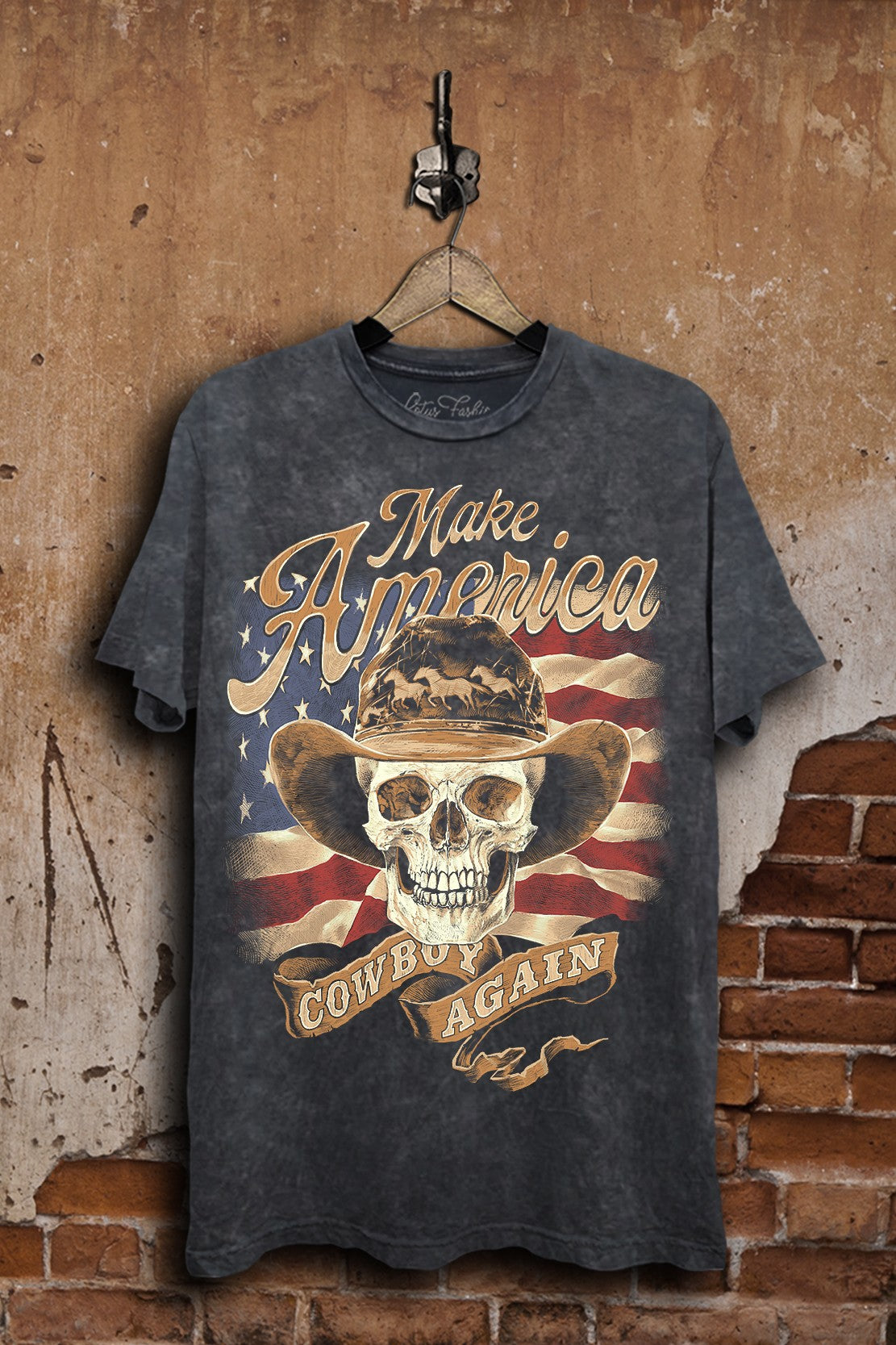 Vintage black mineral-wash boyfriend tee featuring Make America Cowboy Again lettering, a cowboy skull, and a distressed American flag.