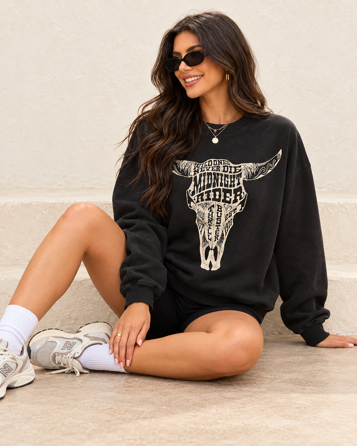 Black French terry crewneck sweatshirt featuring a cream typographic cow skull with prominent Midnight Rider and Wild Ones Never Die lettering.