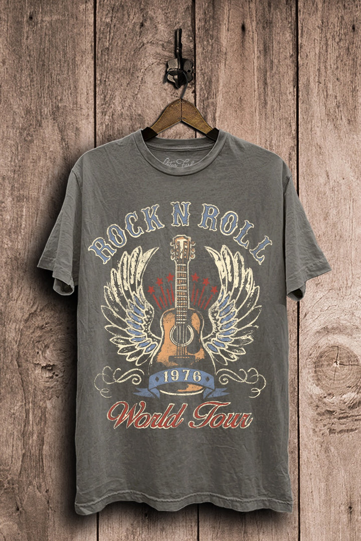 Stone gray mineral-washed plus-size boyfriend tee featuring a distressed acoustic guitar with wings, stars, 1976 banner, and Rock N Roll World Tour lettering.