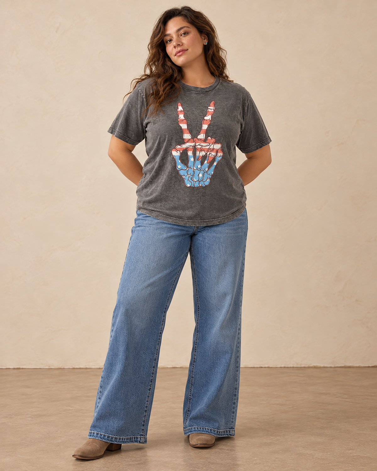 Stone gray mineral-washed plus-size boyfriend tee featuring a skeleton hand peace sign filled with red, white, and blue stars and stripes.