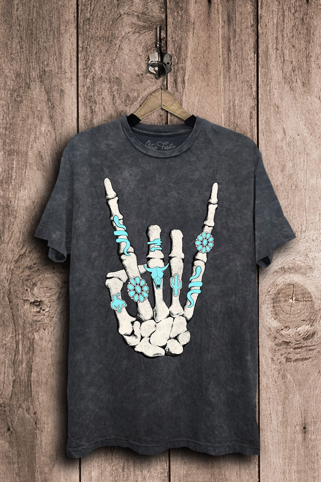 Vintage black mineral-wash boyfriend tee with a turquoise-accented western skeleton hand rock-sign graphic.