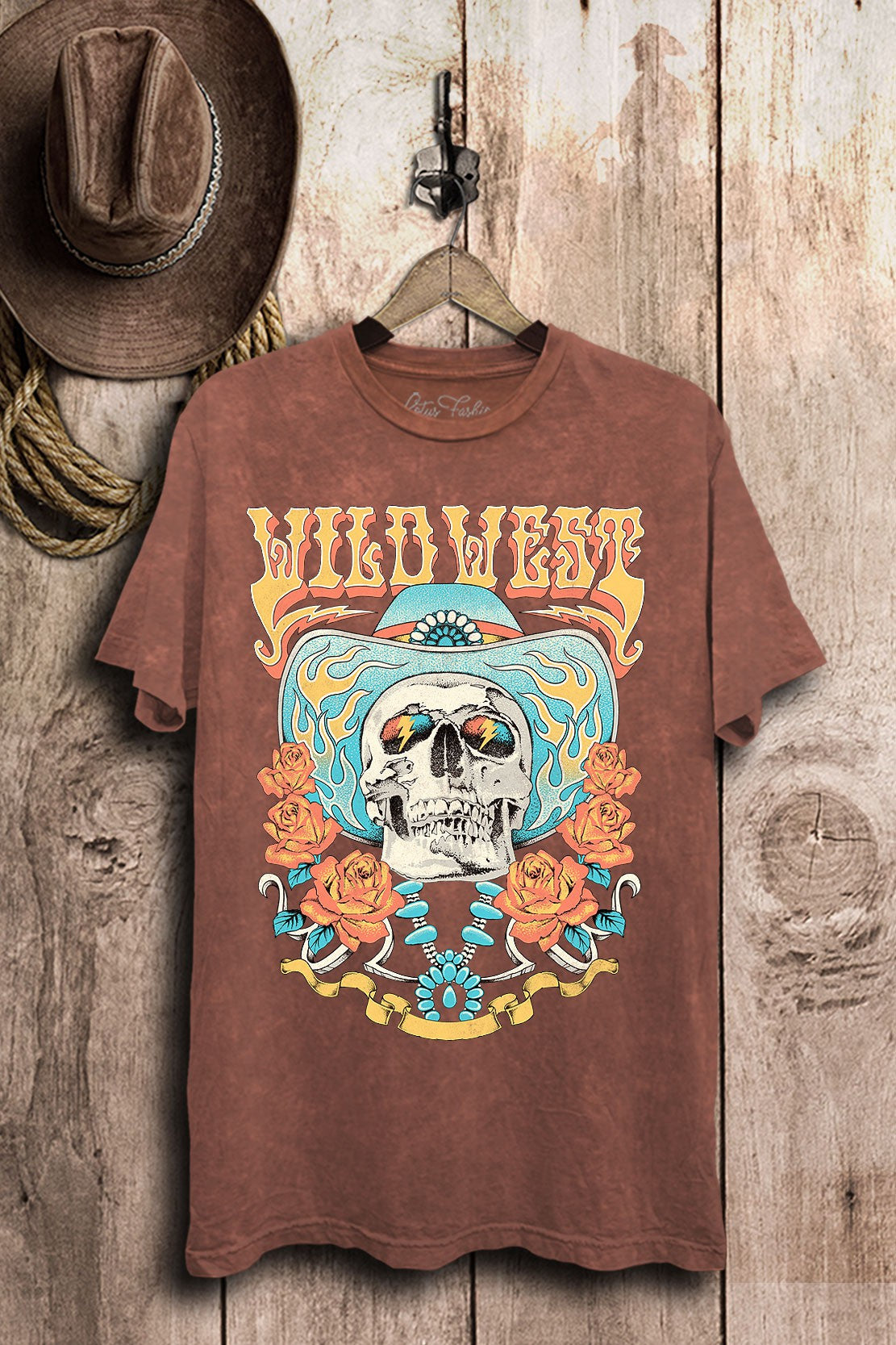 Wine mineral-wash boyfriend tee with a colorful Wild West cowboy skull, turquoise, and rose graphic.