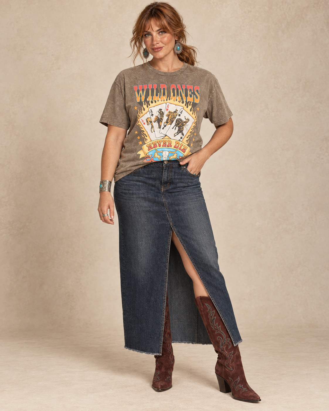 Mocha mineral-wash boyfriend tee featuring Wild Ones Never Die lettering, flaming cowboy playing cards, stars, and a longhorn skull.