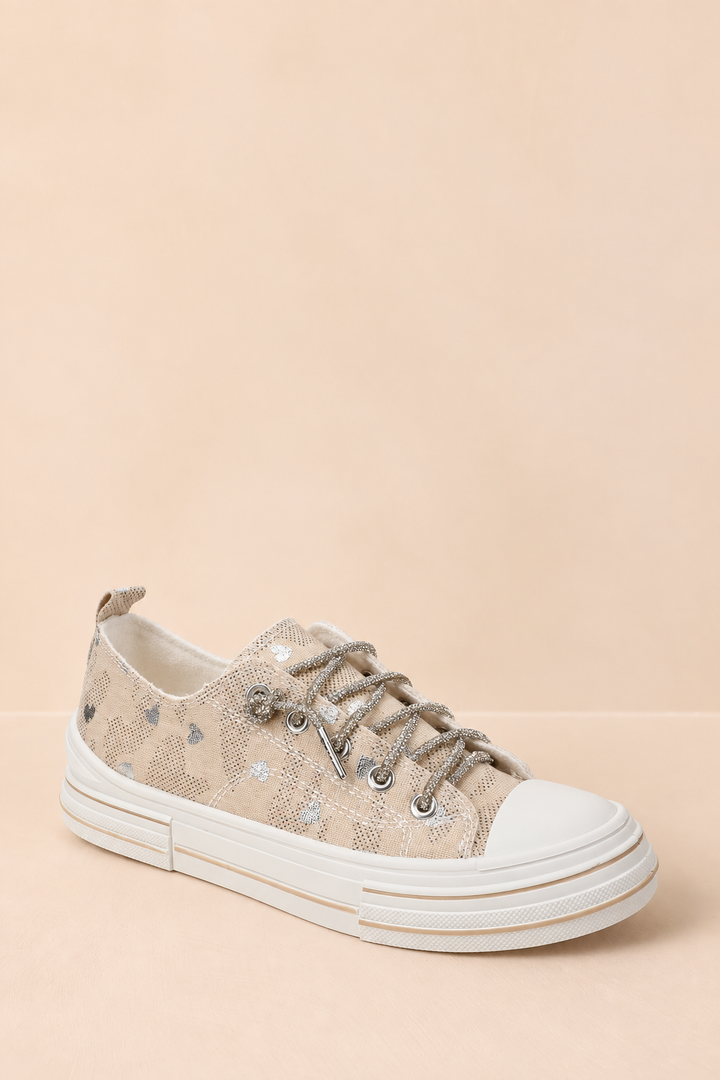 Natural canvas Very G platform sneaker with metallic silver hearts, rhinestone laces, a white rubber toe cap, and a chunky white sole.