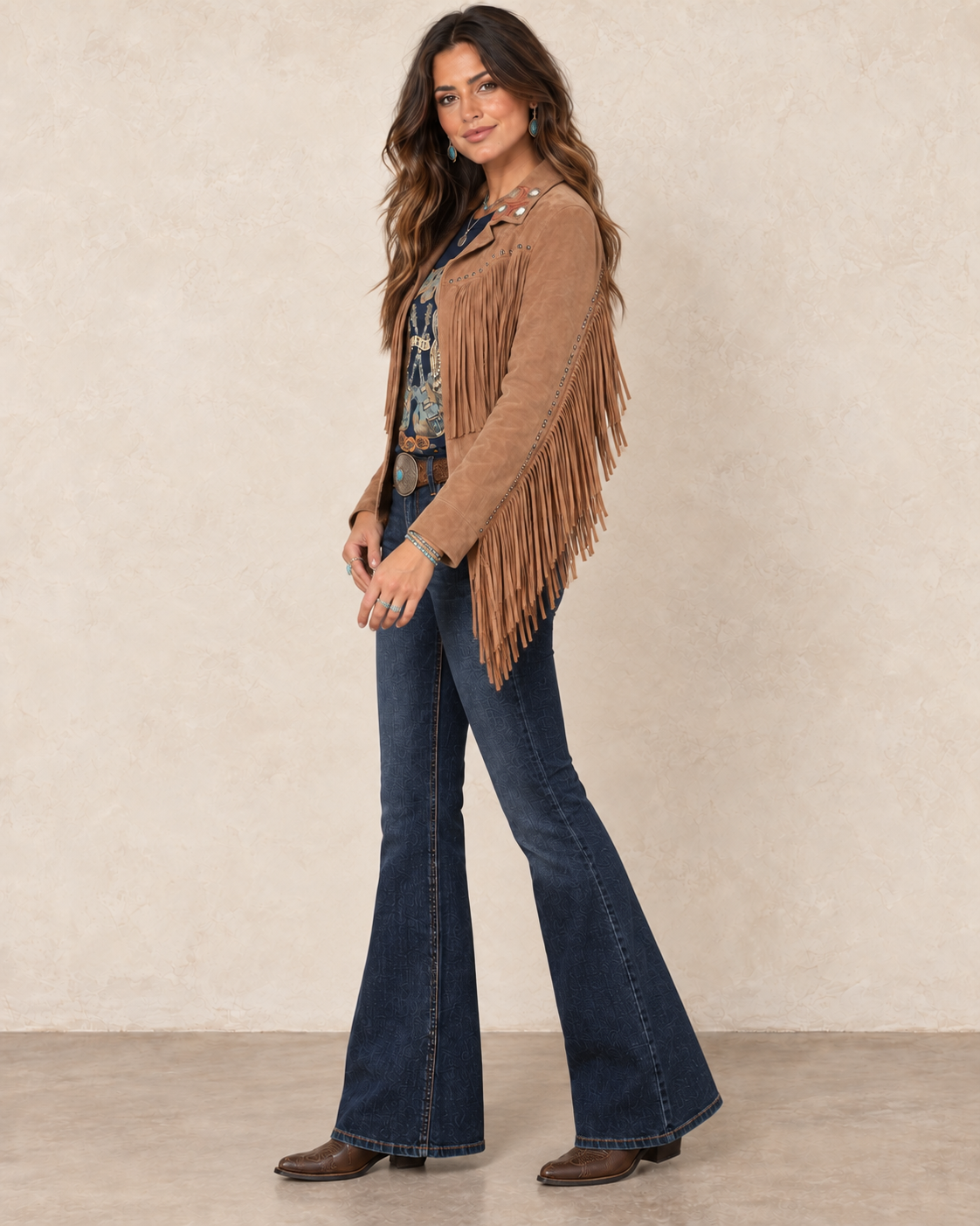 Warm saddle-tan suede leather jacket with an embroidered western collar, antique-tone studs, and long fringe across the front, back, and sleeves.